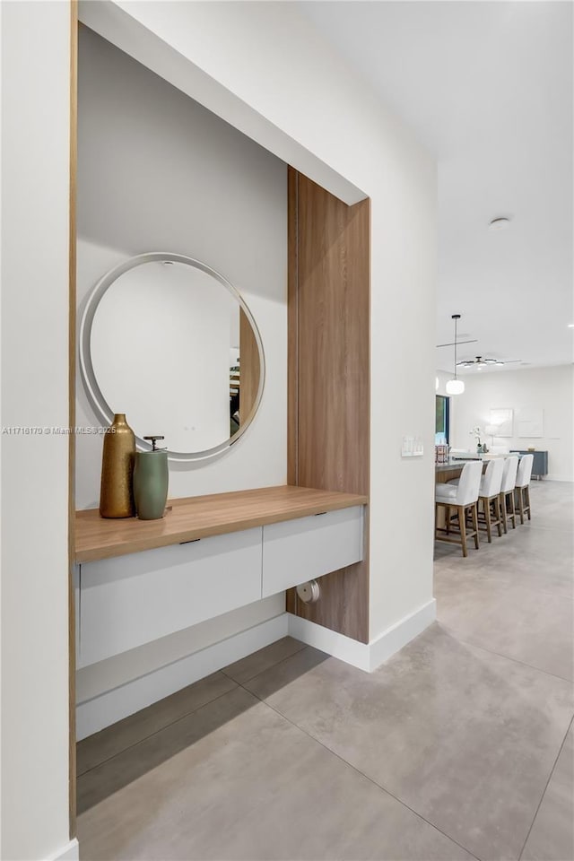 bathroom featuring ceiling fan and concrete flooring