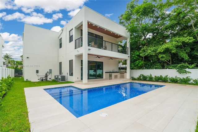 view of pool with area for grilling, ceiling fan, and a patio area