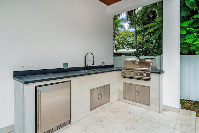 view of patio with an outdoor kitchen, a grill, and sink