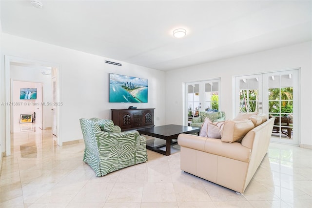 living room featuring french doors and plenty of natural light