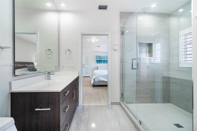 bathroom with vanity, toilet, and walk in shower