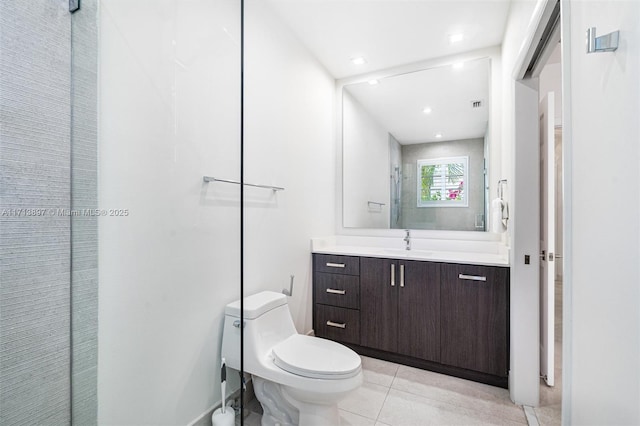 bathroom with vanity, tile patterned floors, and toilet