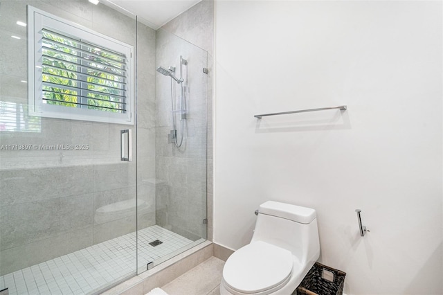 bathroom featuring an enclosed shower and toilet