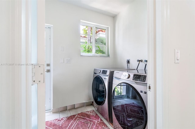 laundry area featuring washer and clothes dryer and tile patterned floors