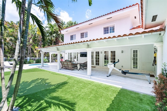 back of house with a patio, outdoor lounge area, ceiling fan, a fenced in pool, and french doors