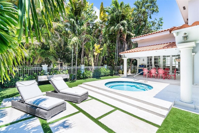 view of swimming pool with an in ground hot tub and a patio