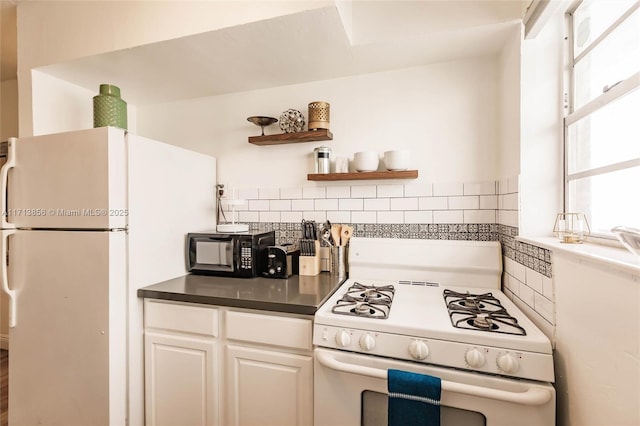 kitchen with white appliances and white cabinetry