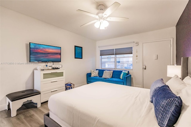 bedroom with ceiling fan and light hardwood / wood-style floors