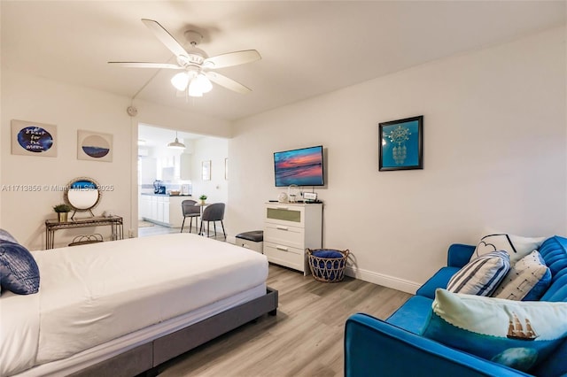 bedroom with ceiling fan and light hardwood / wood-style floors