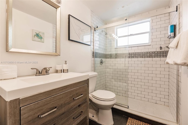 bathroom with a shower with door, tile patterned flooring, vanity, and toilet