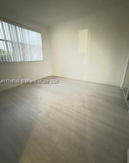 empty room with wood-type flooring