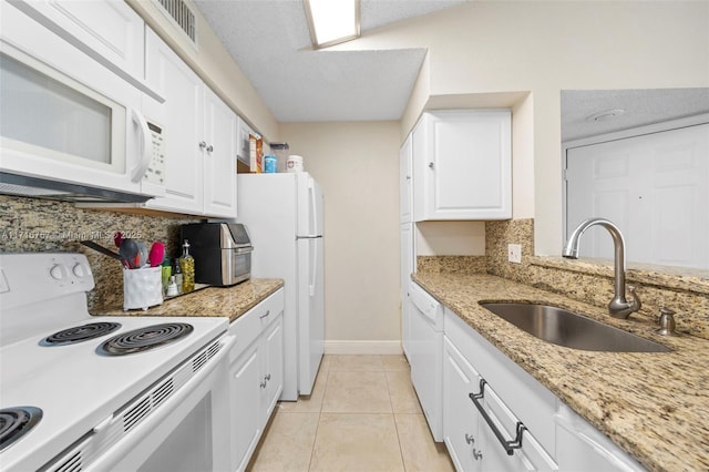 kitchen featuring white cabinets, backsplash, white appliances, and sink