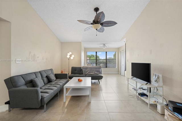 tiled living room featuring ceiling fan and a textured ceiling