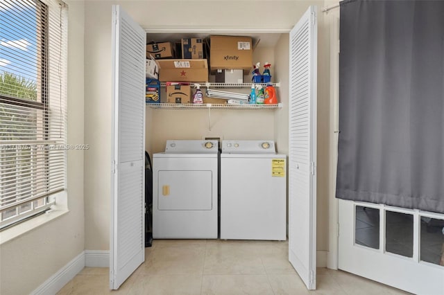 laundry area featuring light tile patterned flooring and independent washer and dryer