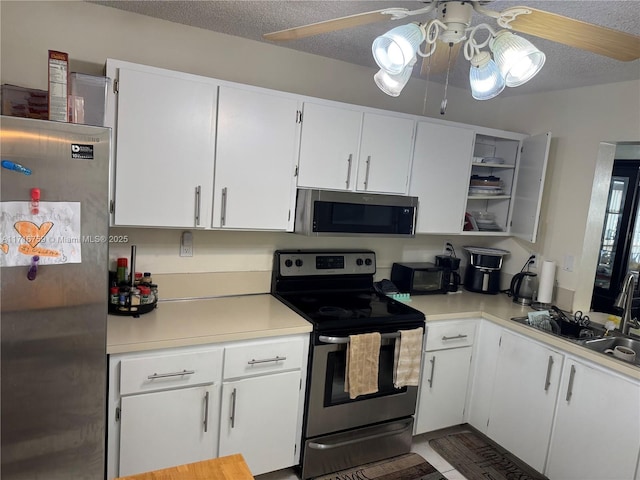 kitchen featuring sink, white cabinetry, a textured ceiling, and appliances with stainless steel finishes