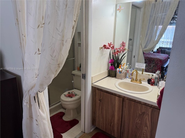 bathroom with vanity, toilet, and walk in shower