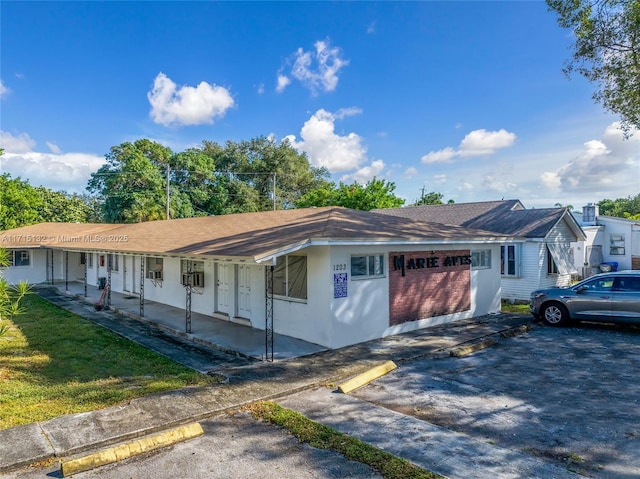 single story home with a porch and a garage