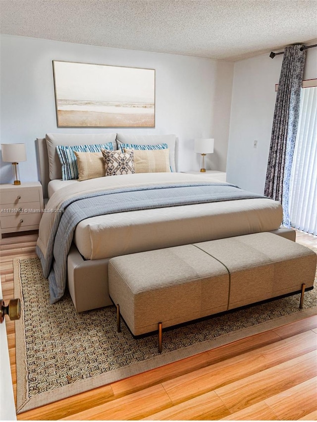 bedroom featuring hardwood / wood-style floors and a textured ceiling