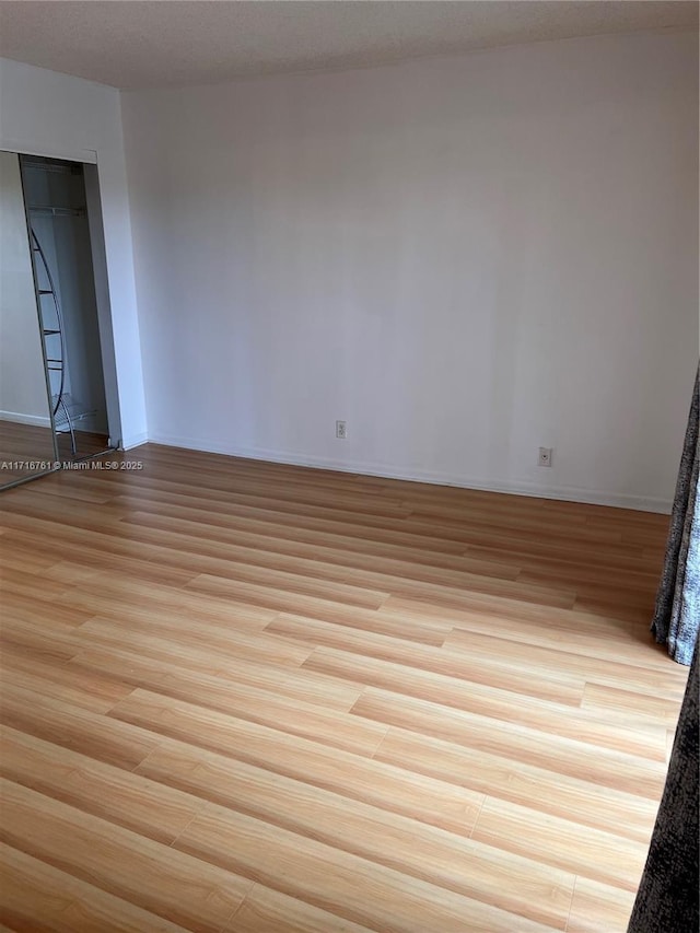 empty room with light hardwood / wood-style floors