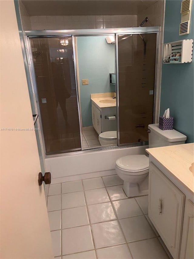 full bathroom featuring tile patterned flooring, vanity, toilet, and shower / bath combination with glass door