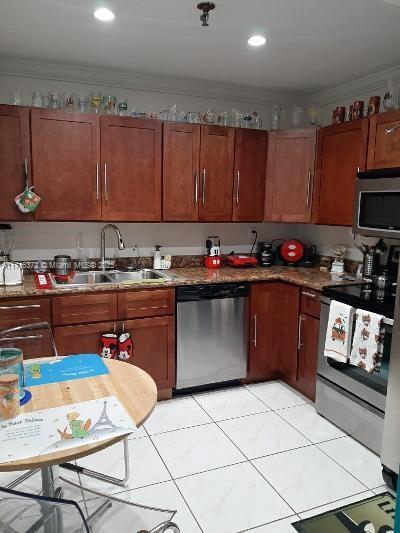 kitchen featuring light tile patterned flooring, appliances with stainless steel finishes, ornamental molding, and sink