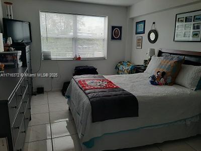 bedroom with light tile patterned floors