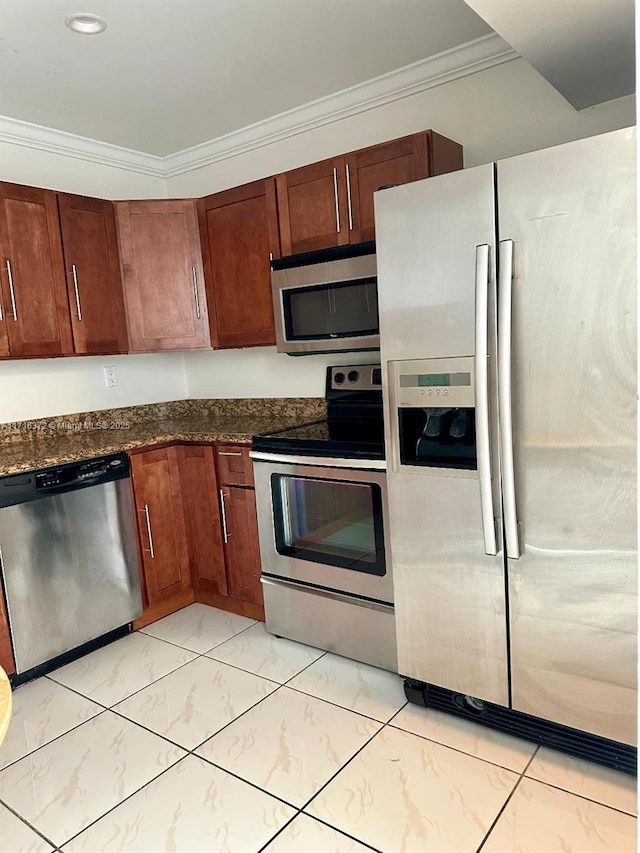 kitchen featuring stainless steel appliances, ornamental molding, and dark stone countertops