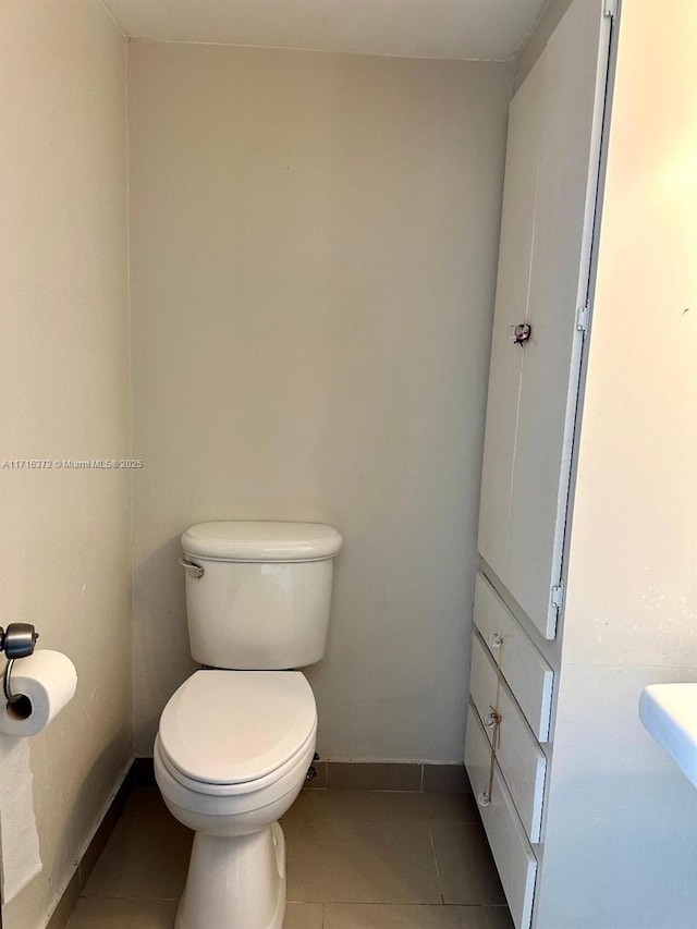 bathroom featuring tile patterned flooring and toilet