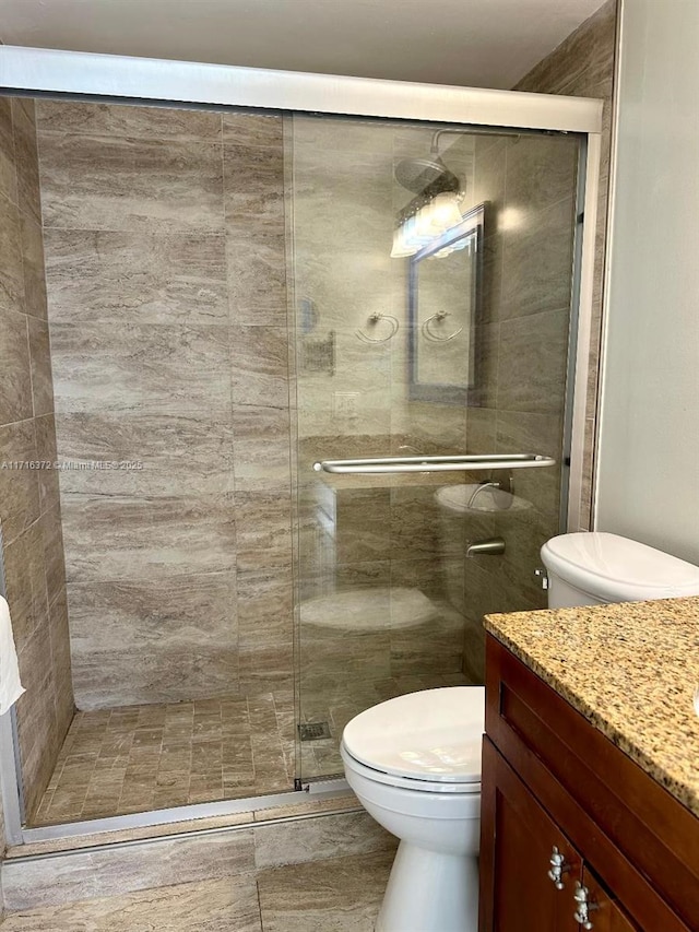 bathroom with vanity, toilet, and walk in shower