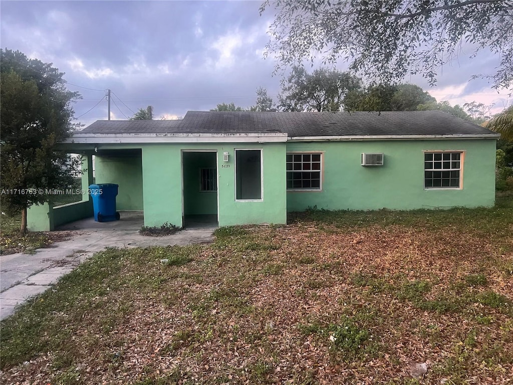 rear view of property featuring a wall mounted AC