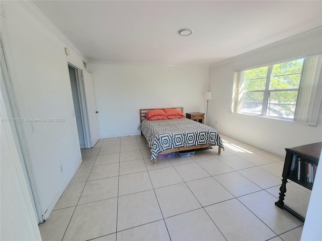 bedroom featuring light tile patterned floors and crown molding