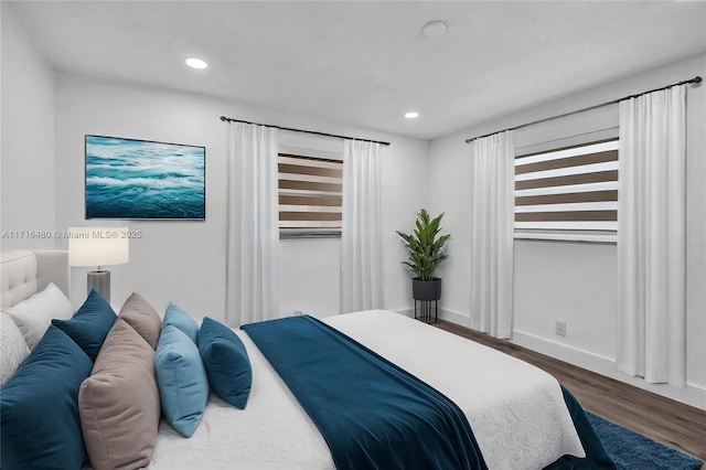 bedroom with dark hardwood / wood-style floors