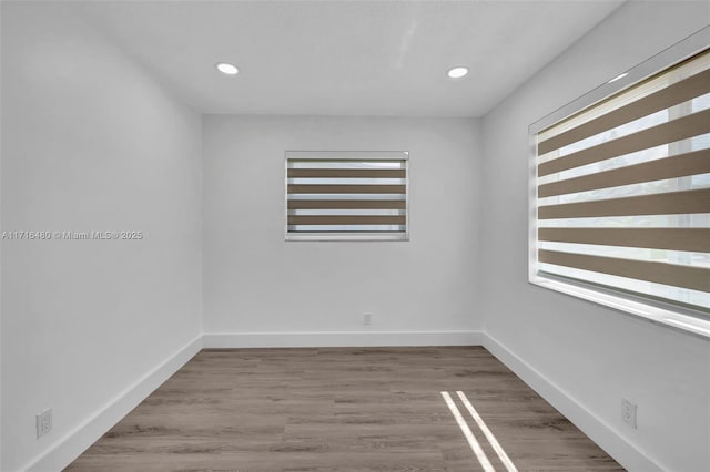 empty room featuring hardwood / wood-style flooring and plenty of natural light