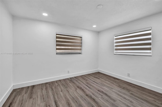 unfurnished room featuring hardwood / wood-style floors and plenty of natural light