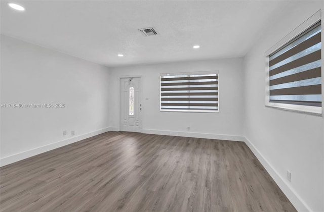 spare room with wood-type flooring