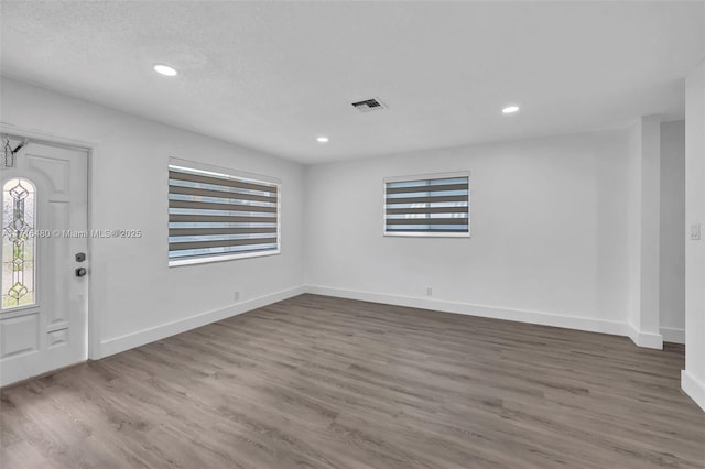 foyer featuring wood-type flooring and a textured ceiling