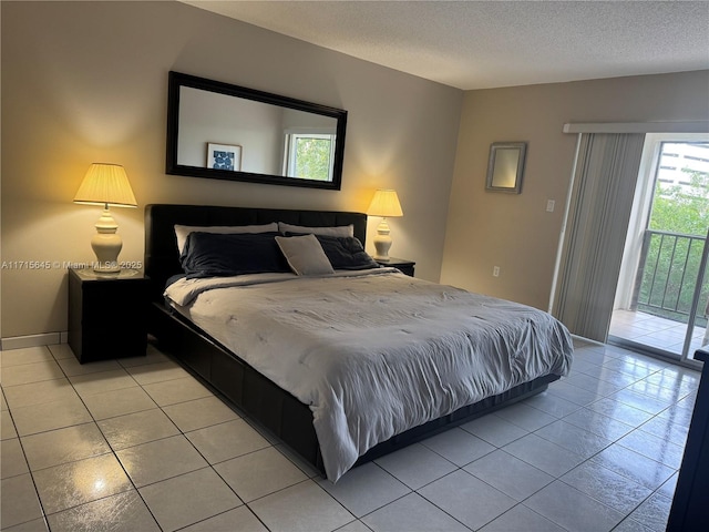 tiled bedroom featuring a textured ceiling and access to outside