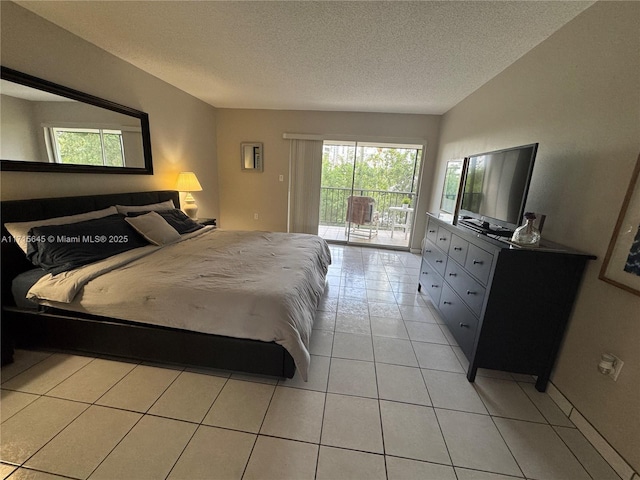 tiled bedroom with a textured ceiling and access to outside