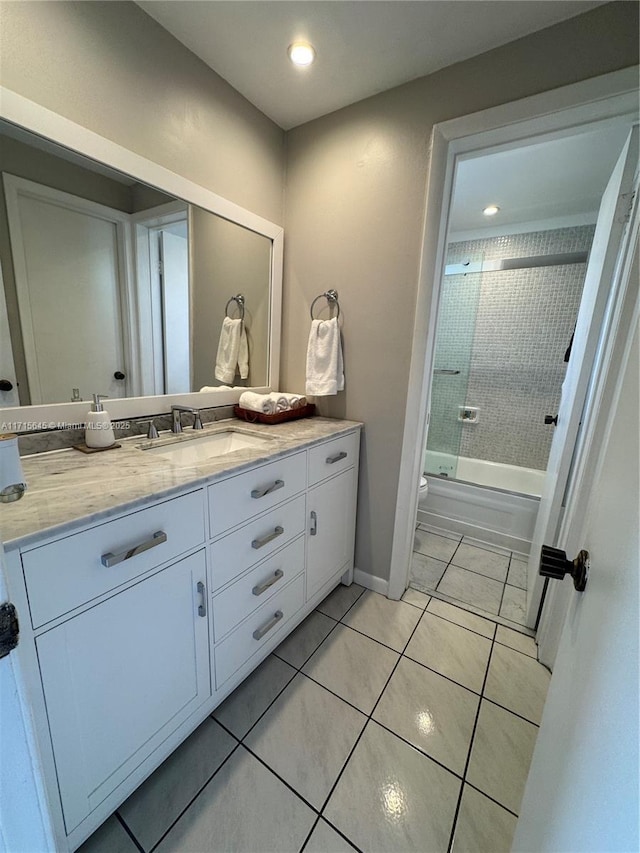 bathroom featuring tiled shower / bath combo, vanity, and tile patterned floors