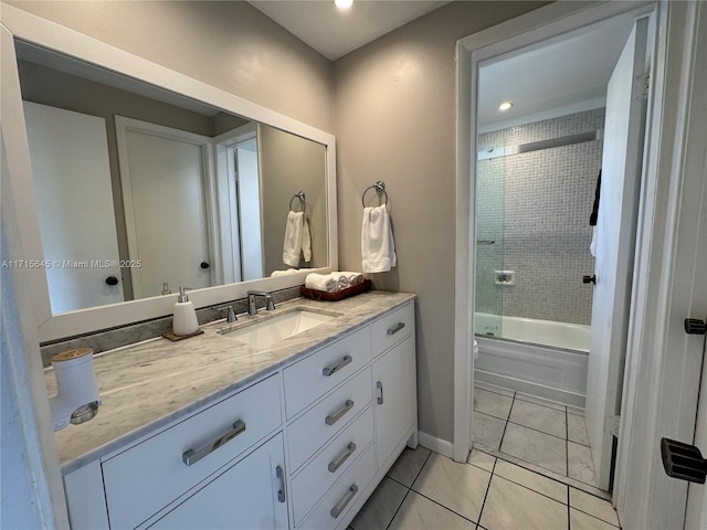 bathroom featuring tile patterned flooring, enclosed tub / shower combo, and vanity