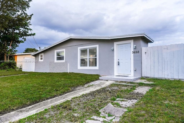 ranch-style home with a front lawn