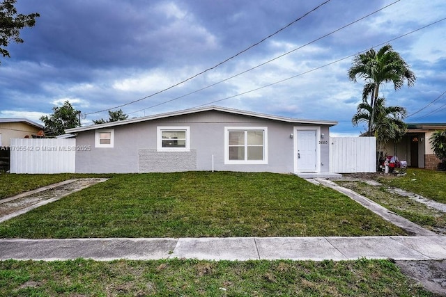 ranch-style home featuring a front yard