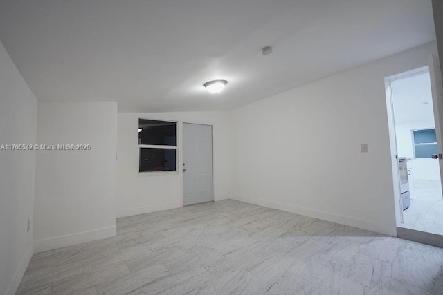 unfurnished room featuring lofted ceiling