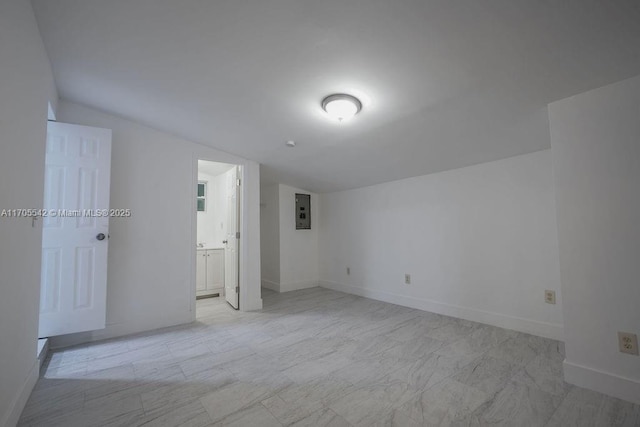 empty room with electric panel and lofted ceiling