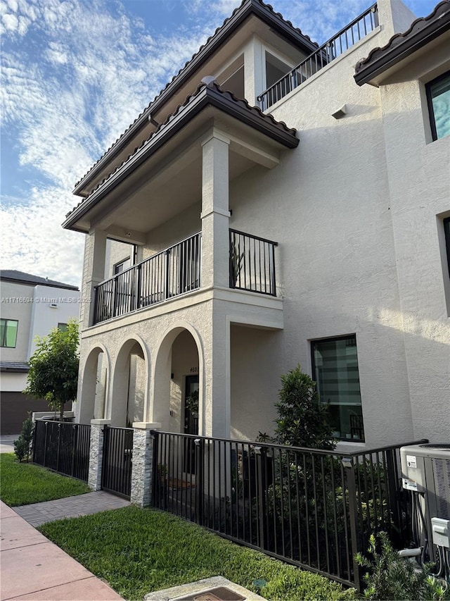 view of property exterior featuring cooling unit and a balcony