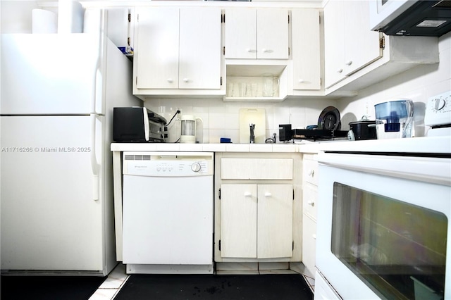 kitchen with backsplash, white cabinets, exhaust hood, and white appliances