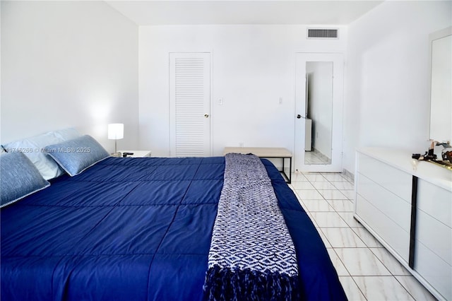 bedroom with light tile patterned floors