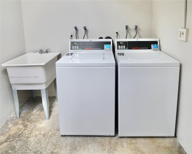 washroom with independent washer and dryer and sink