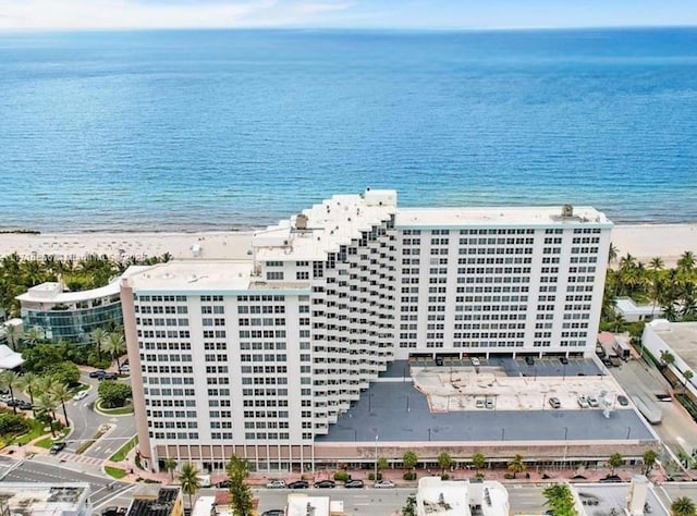 drone / aerial view with a water view and a beach view