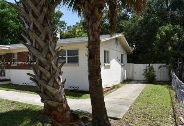 view of side of property with a yard